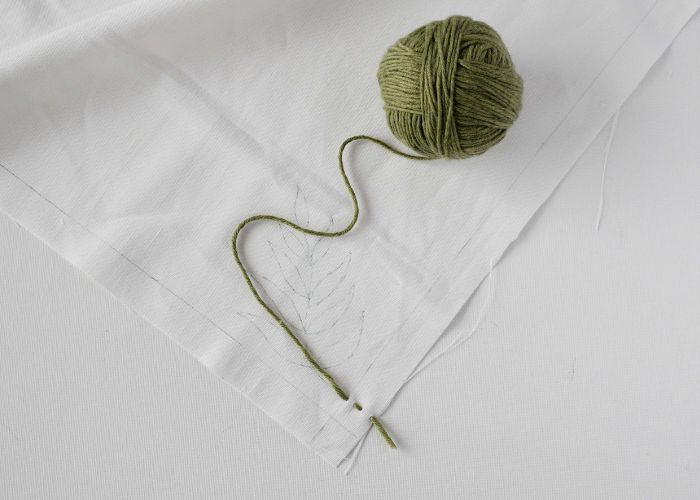 Make a couple of tiny running stitches