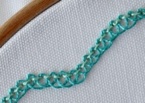 Pekinese Stitch embroidery with green pearl cotton image